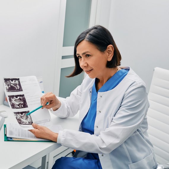 Female Doctor showing ultrasound scan and explaining what's in them