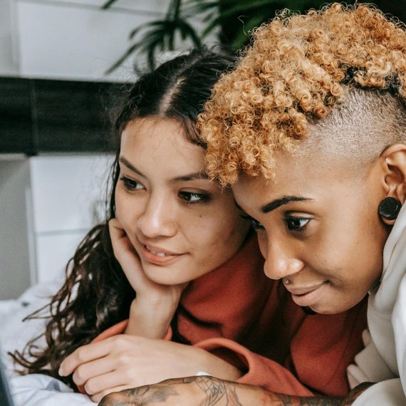 Two people close together looking at a screen