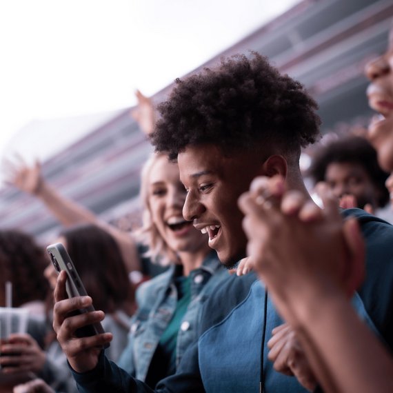 Individual at event holding up smartphone