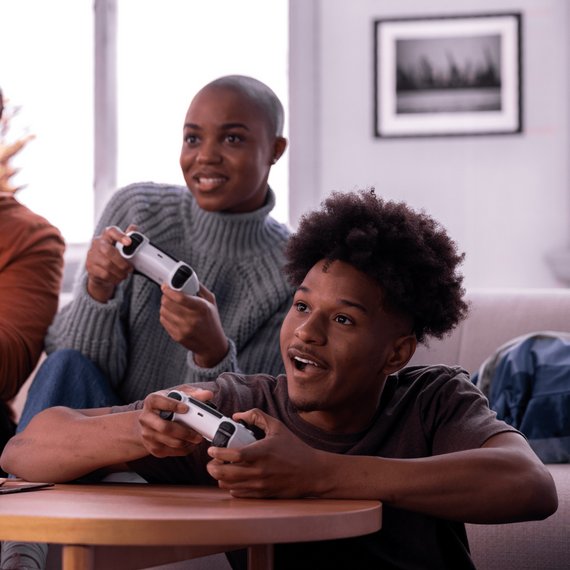 Two people playing video games with controllers