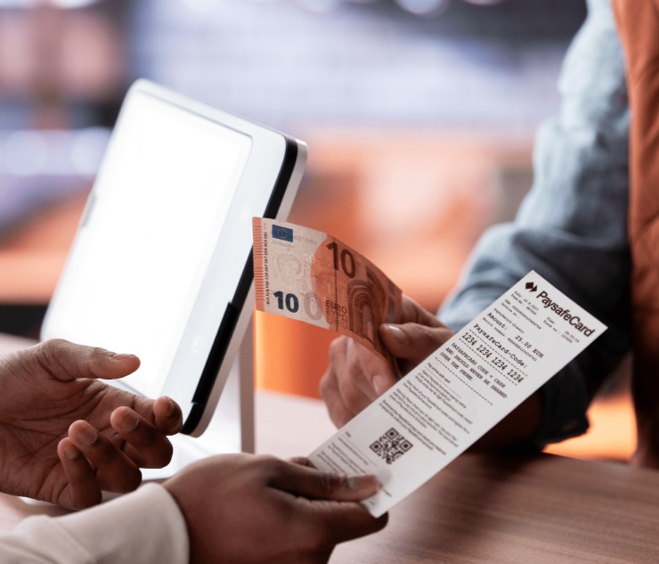 Transaction at counter: Person hands over ten euro and ticket