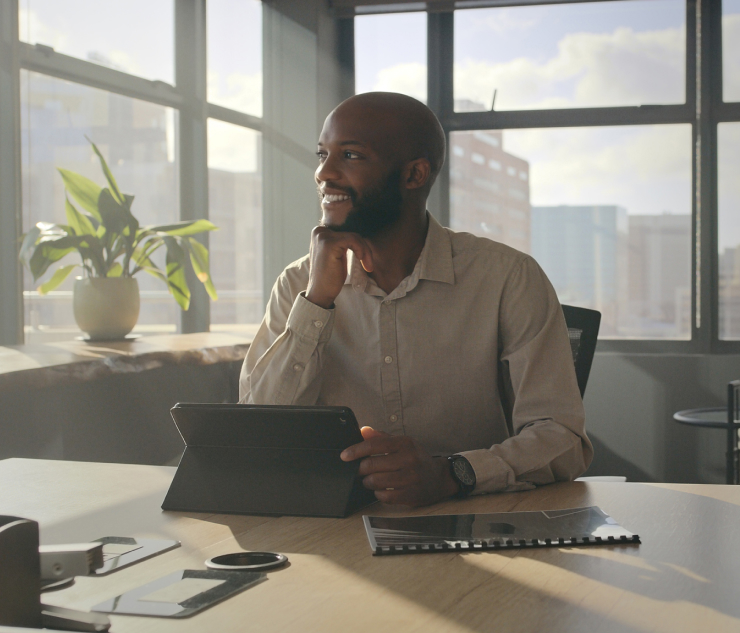 Person at desk with tablet