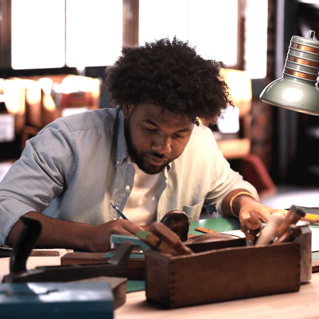 Individual Engaged in Woodworking in a Workshop