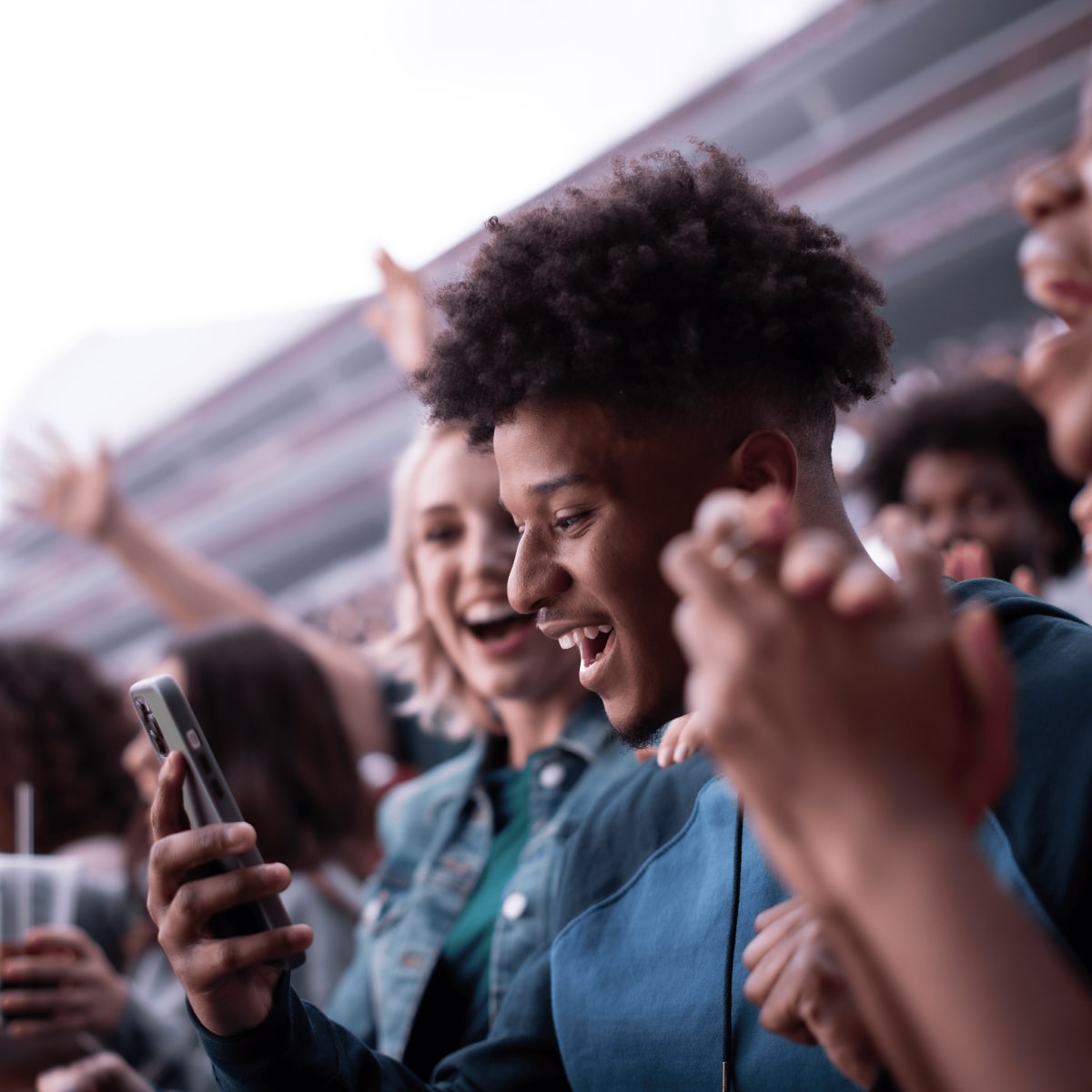 Individual at event holding up smartphone